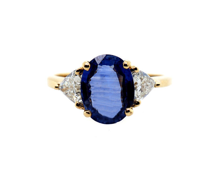 3.50ct Oval Sapphire and 0.80ctw Trillion Cut Diamond Three Stone Ring in 18K